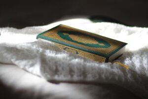 Qur’an placed in a peaceful atmosphere, symbolizing spiritual protection through Surah Al-Falaq