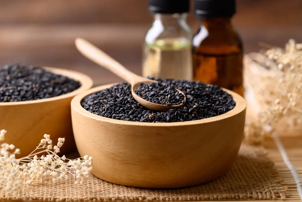 Black cumin seeds with oil on a table