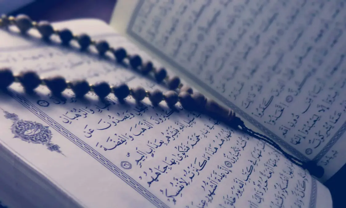 Coran ouvert avec chapelet, pour illustrer l’étude du tafsir en ligne