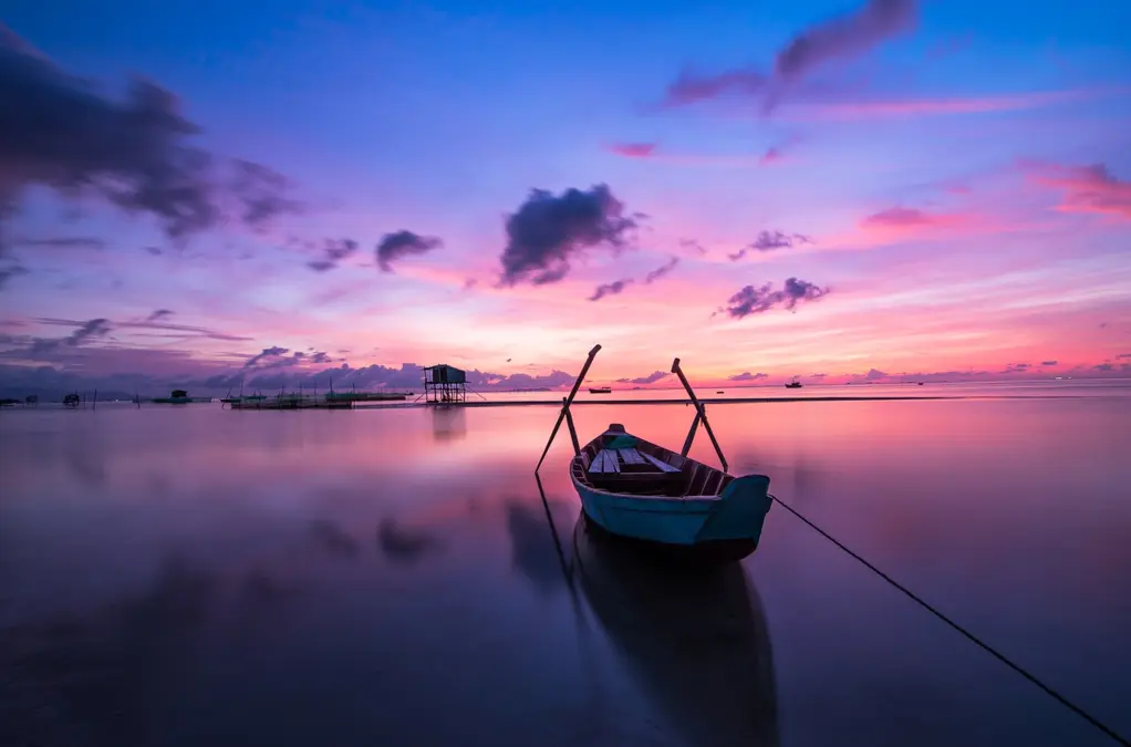Barque sur une eau calme au lever du jour