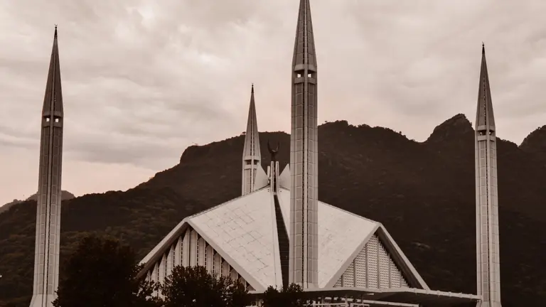 Modern mosque with minarets before mountains