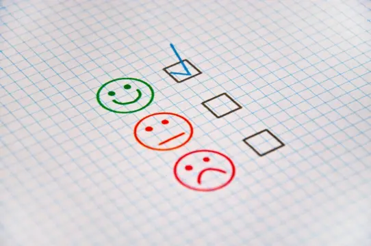 Exam sheet with checkboxes and evaluation faces