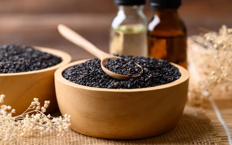 Black cumin seeds with oil on a table