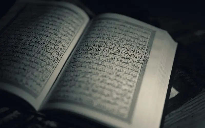 Open Quran in dark meditative light