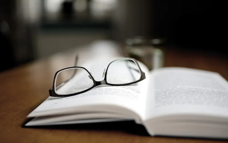 Open book with glasses for studying