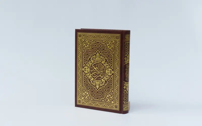 Closed Quran placed on a white background