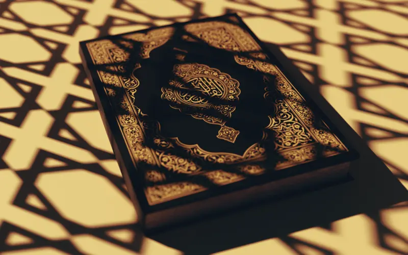 Quran under light with Islamic patterns