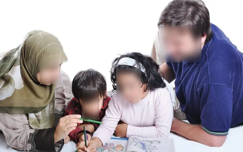 Parents helping their children study at home