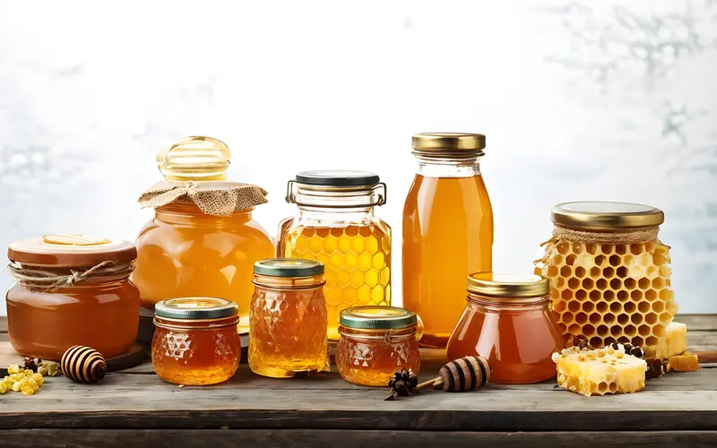 Jars of natural golden honey on a table