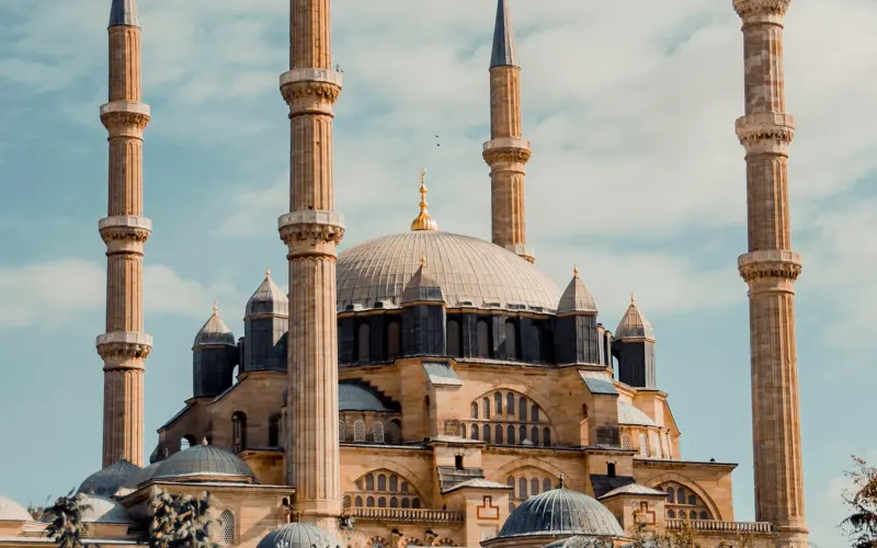Mosque with domes and minarets under a blue sky