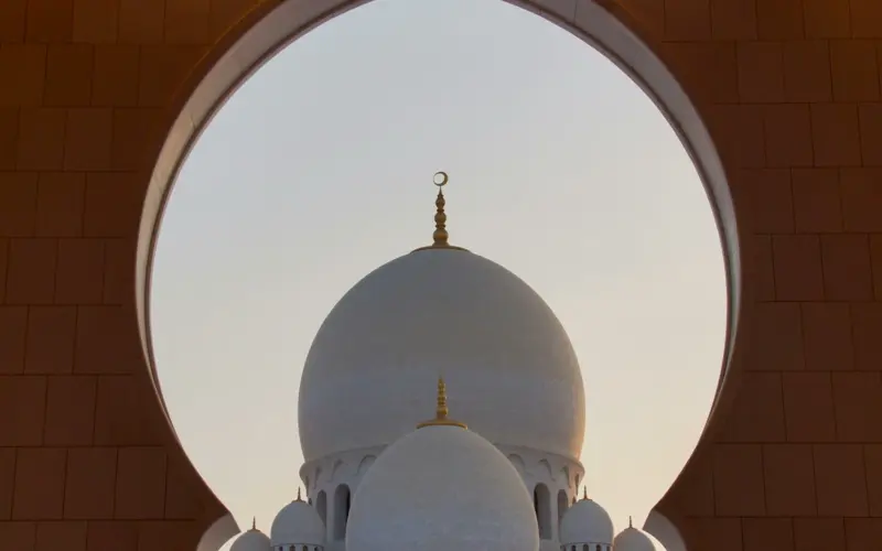 Mosque seen through an Islamic arch