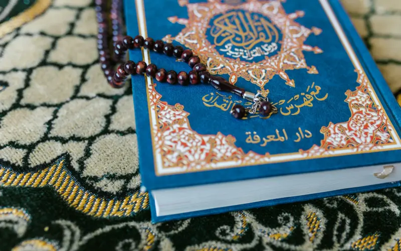 Quran with prayer beads illustrating Quran recitation styles
