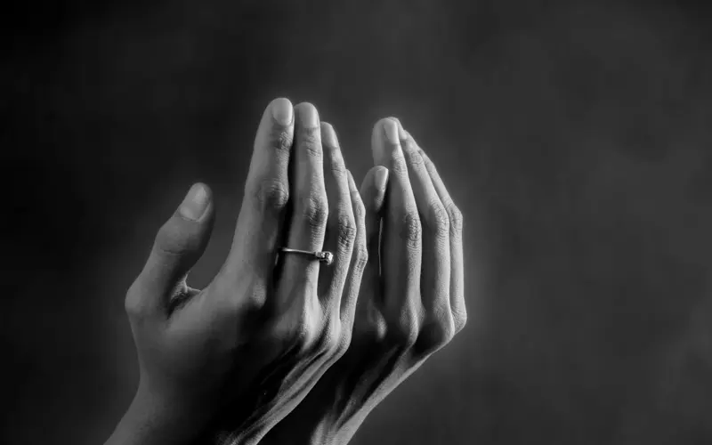 Hands raised in supplication for Istikhara prayer