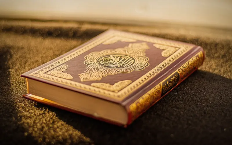 Closed Quran placed on a carpet