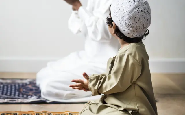 Kind lernt islamische Bittgebete beim Gebet