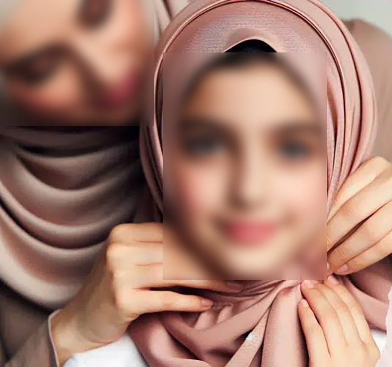 Mother helping her daughter wear the hijab
