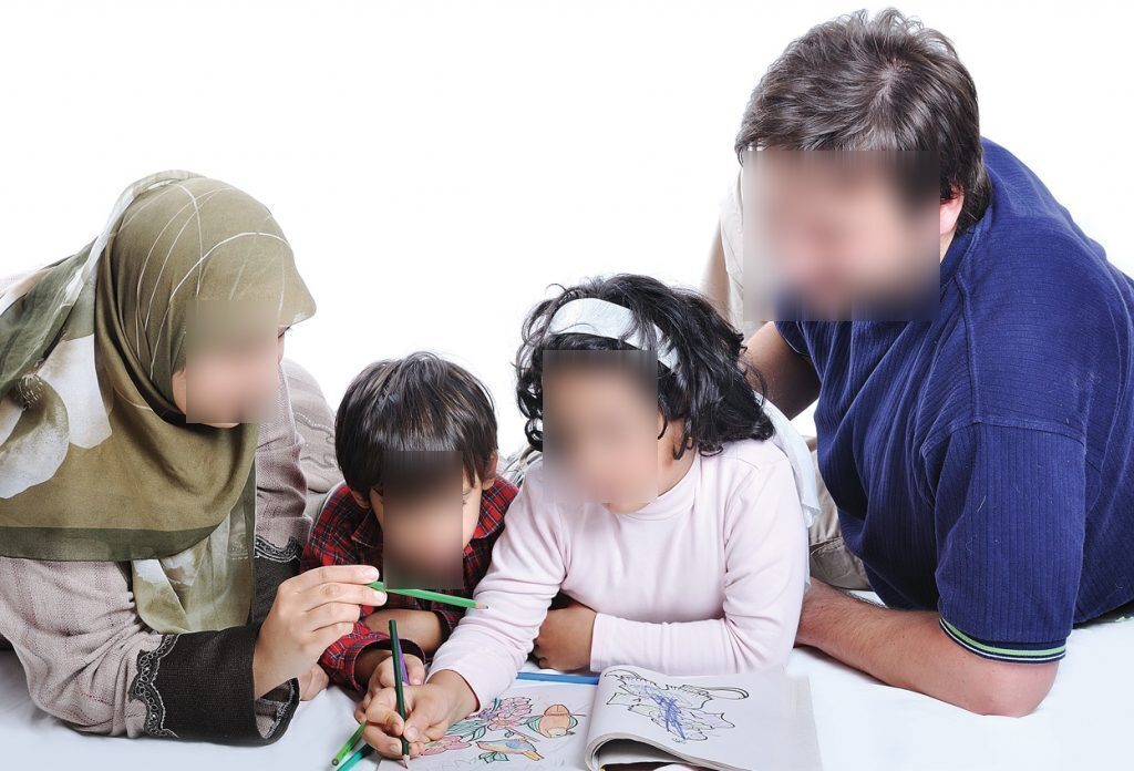 Parents helping their children study at home