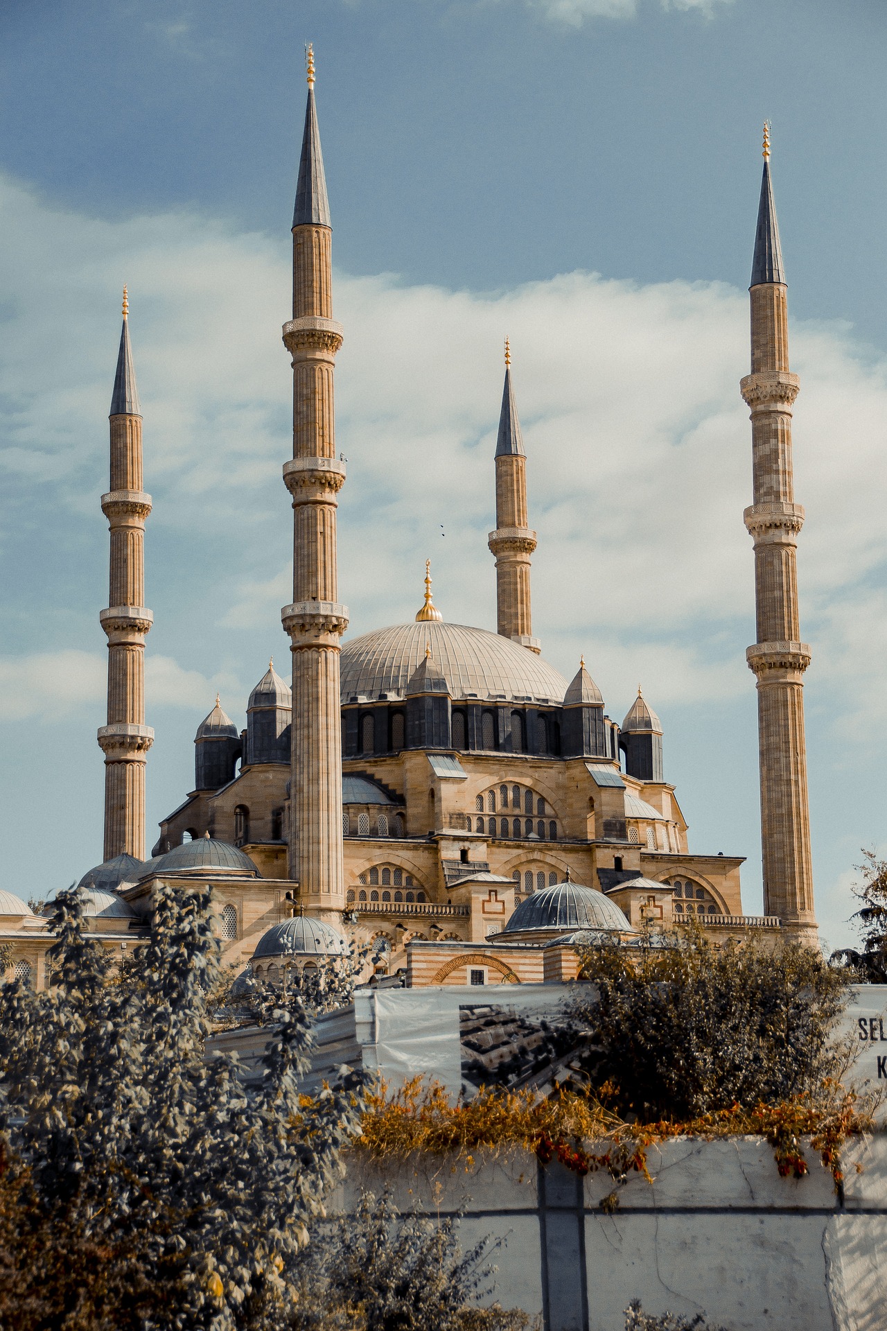 Mosque with domes and minarets under a blue sky