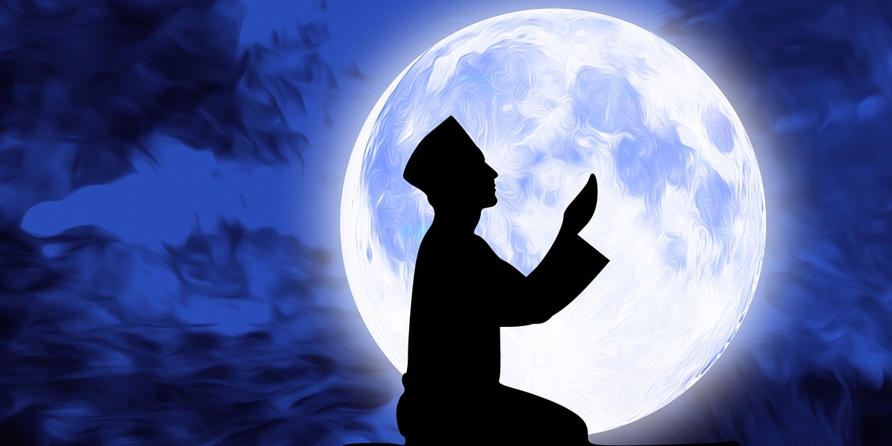 Silhouette praying before the moon for deceased parents