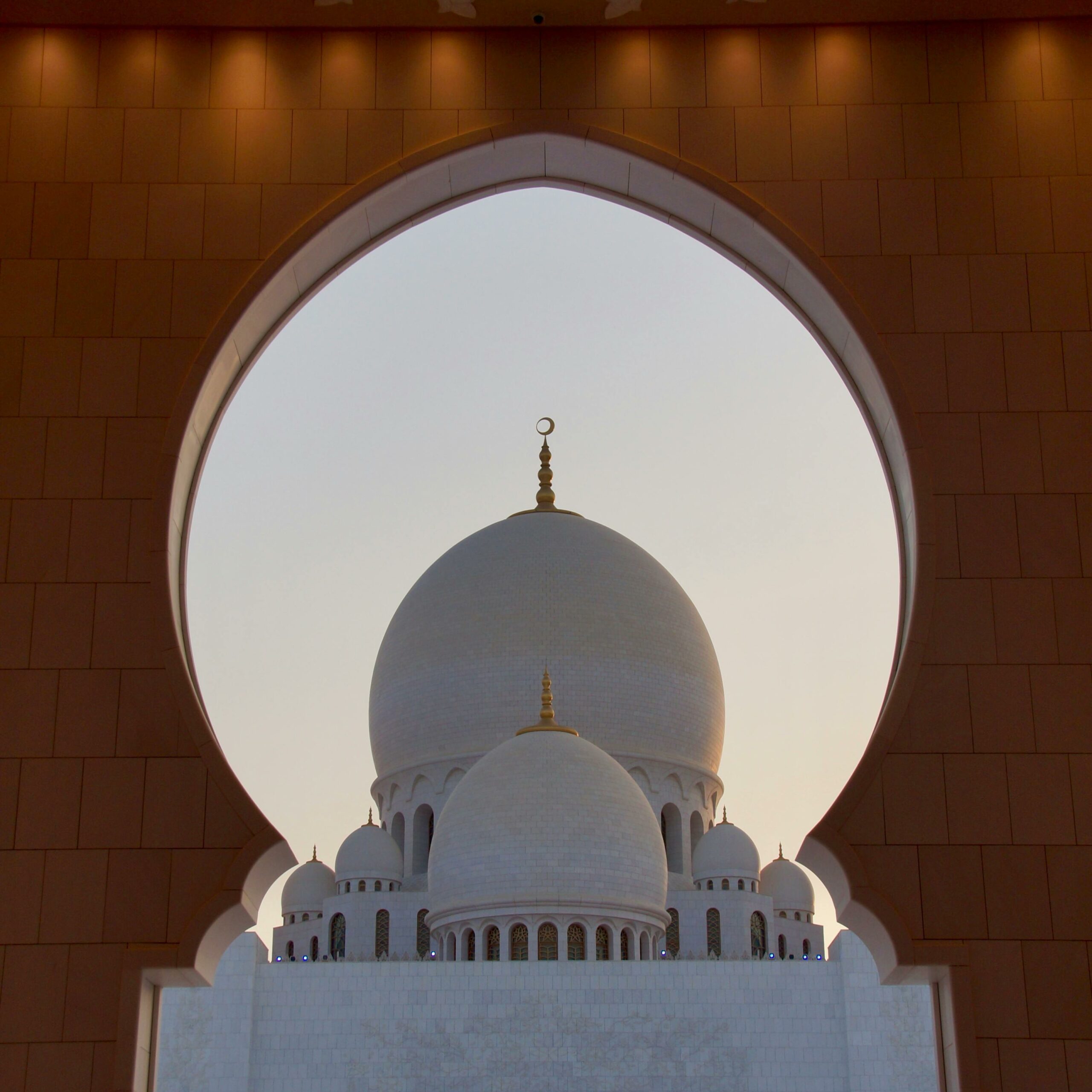 Mosque seen through an Islamic arch