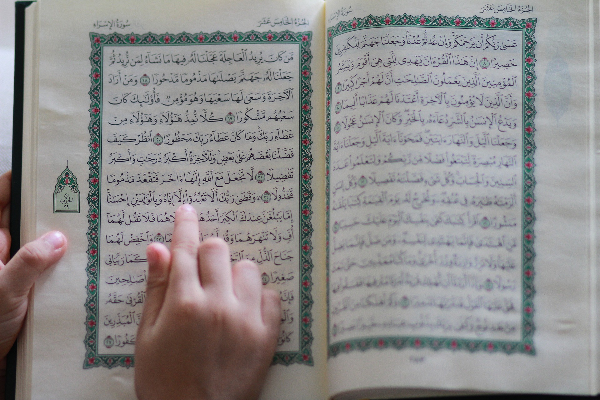 Reading the Quran while following the verses by hand