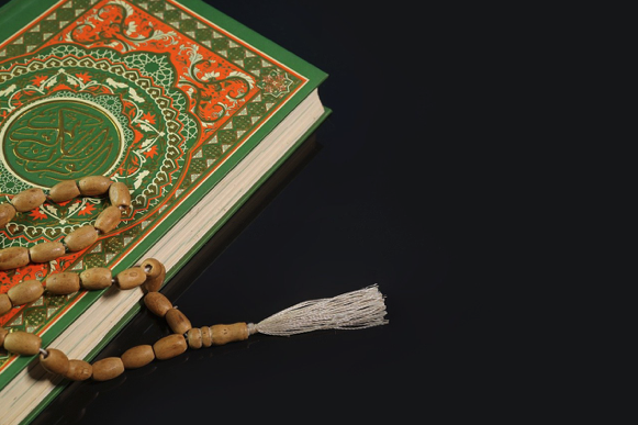 Quran with prayer beads illustrating Tajweed and Quranic Arabic